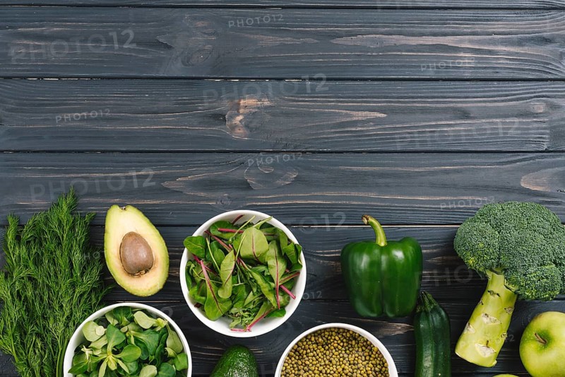 Green fresh vegetables black wooden desk