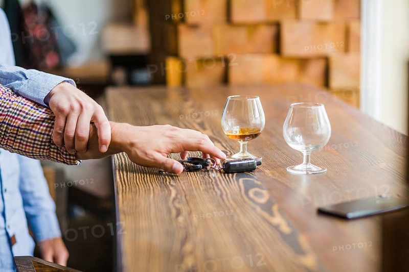 Man avoiding her friend taking car keys table