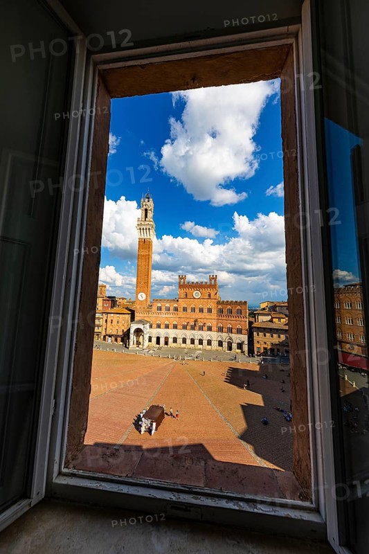 Spring clouds over the Piazza del Campo with the bell tower Torre del Mangia and the town hall Palazzo Pubblico