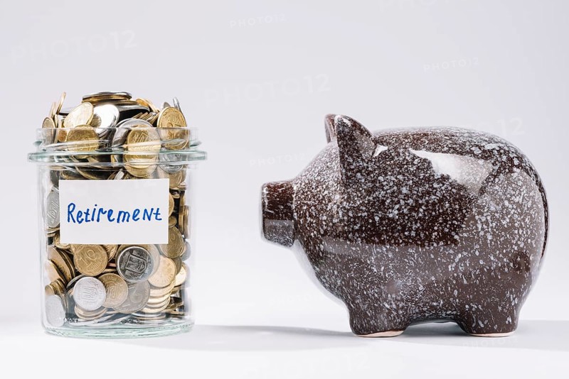 Piggybank near retirement glass container full coins