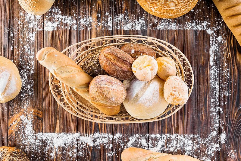 Loaves bread basket inside rectangular frame made with flour