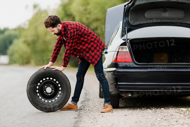 Side view man with spare tyre