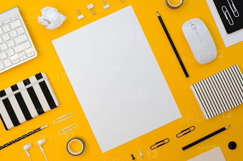 Flat lay office supplies with mouse headphones
