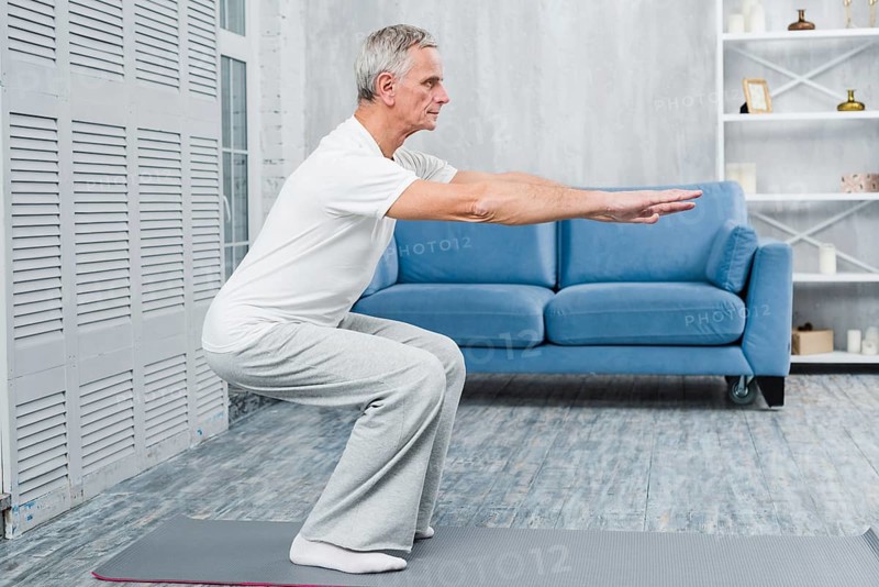 Senior man exercising home