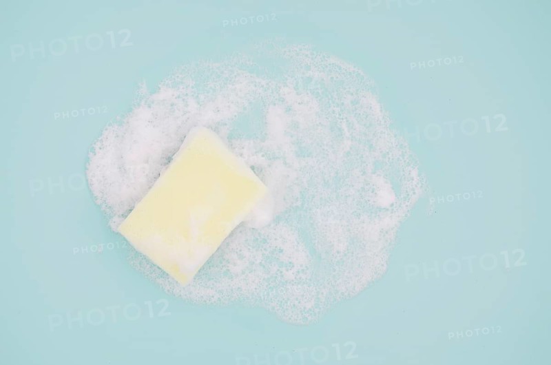 Overhead view sponge with sud blue background