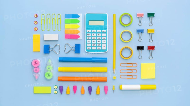 Top view colorful office stationery with calculator paper clips