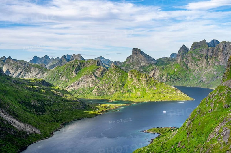 Mountain landscape with pointed mountain peaks and fjord Forsfjorden with village Vindstad