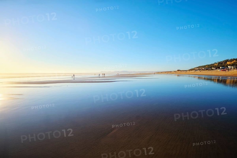 Atlantic ocean sunset with surging waves at Fonte da Telha beach