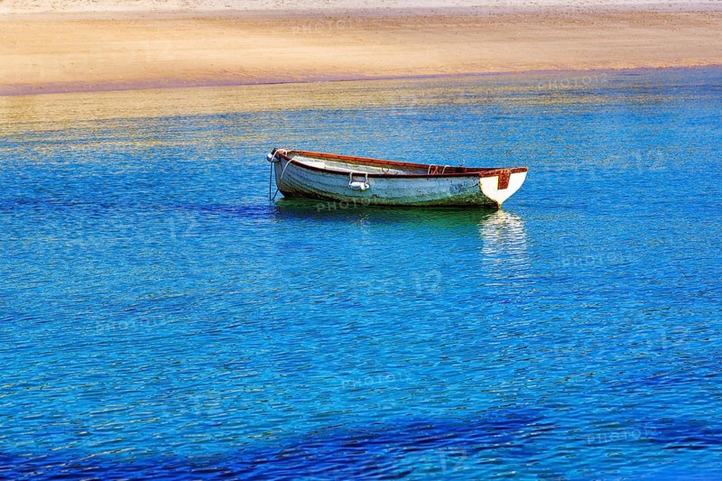 White rowboat on the shore