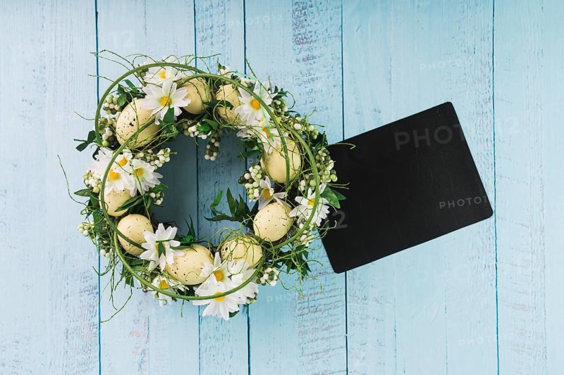 Easter wreath lying near black paper