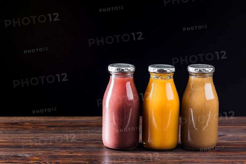 Smoothie bottles wooden surface