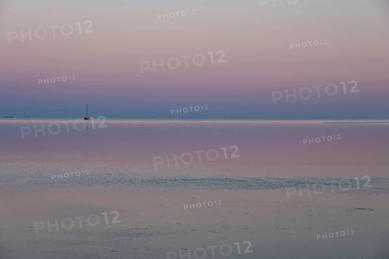 Ship in the Wadden Sea at sunset