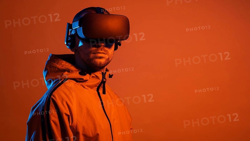 Man wearing virtual reality gadget with orange light