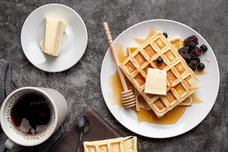 Top view waffles plate with butter cup tea