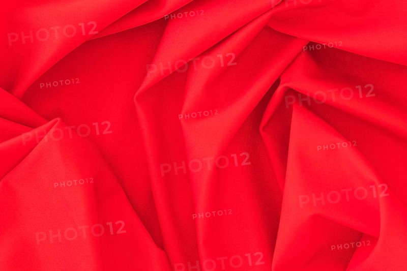 Folded red textile fabric texture background