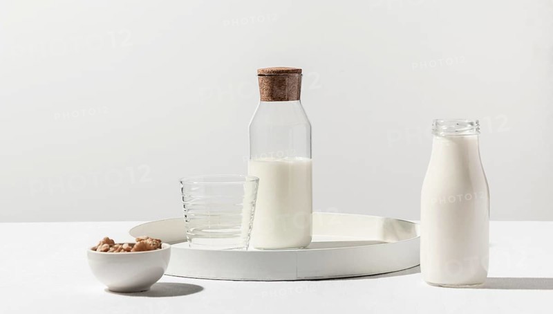 Front view milk bottle with walnuts tray