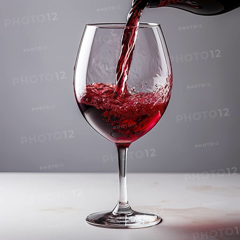 Wine is poured into elegant wine glasses