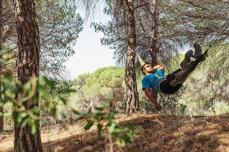 Man taking rest hammock forest