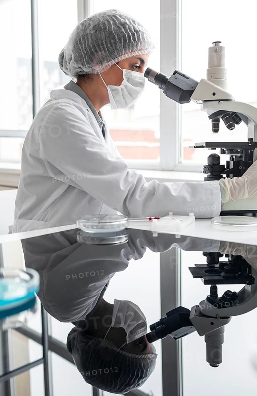 Medium shot researcher working with microscope