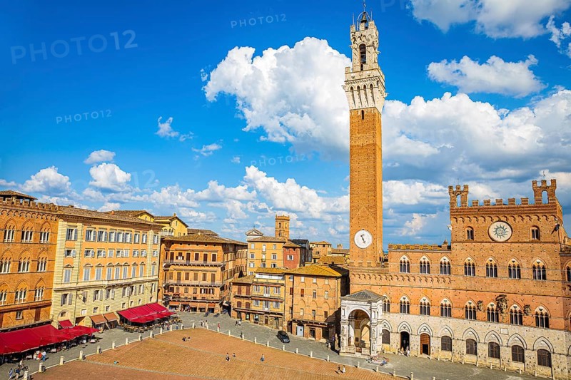 Spring clouds over the Piazza del Campo with the bell tower Torre del Mangia and the town hall Palazzo Pubblico