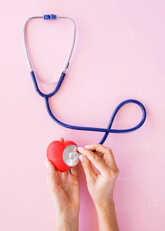 Top view hands checking heart with stethoscope