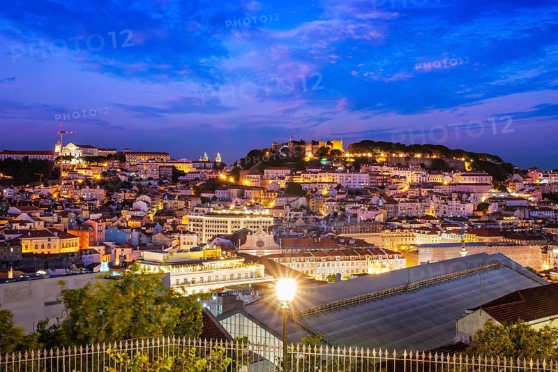 View of Lisbon famous view from Miradouro de Sao Pedro de Alcantara tourist viewpoint in the evening. Lisbon