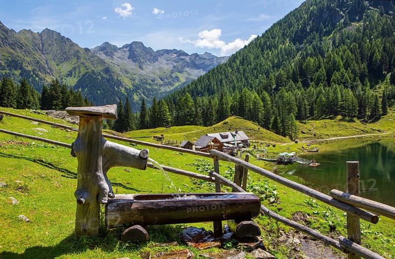 Wooden well on the mountain pasture with Duisitzkarsee