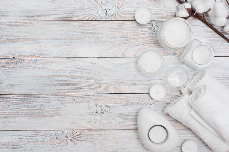 Bath salts cotton flowers wooden background