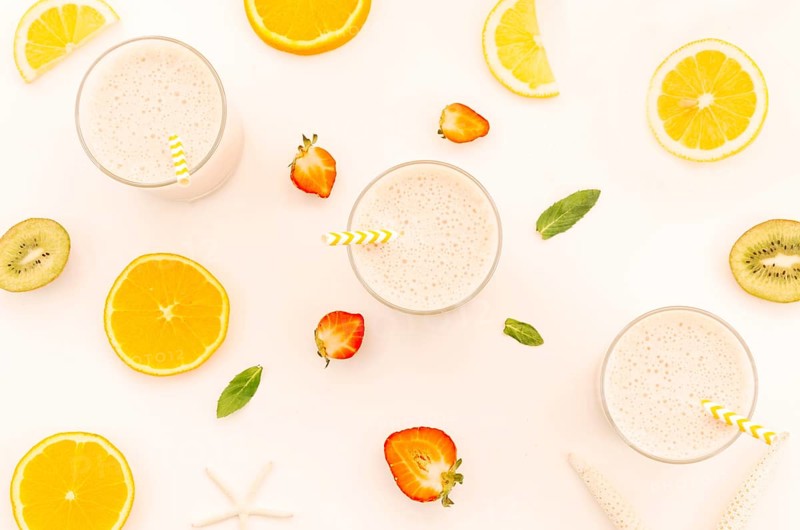 Milkshakes with straws cut fruits berries