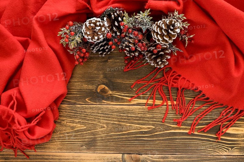 Flat lay cute winter pine cones red scarf