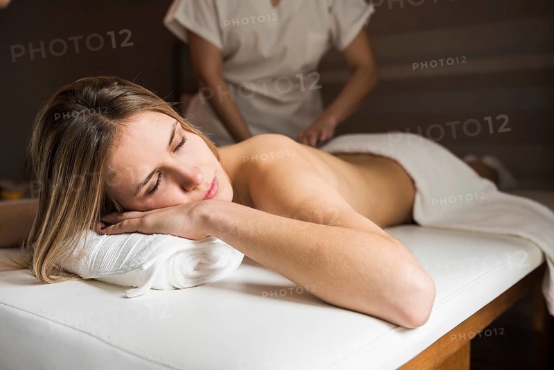 Relaxed woman getting massage spa