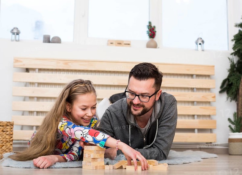 Father daughter playing with wood blocks