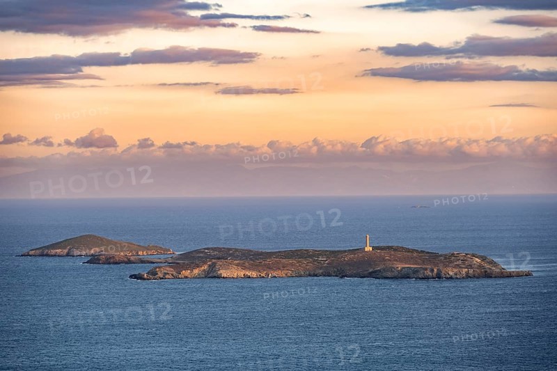 View of the sea and Didimi Island with lighthouse at sunset