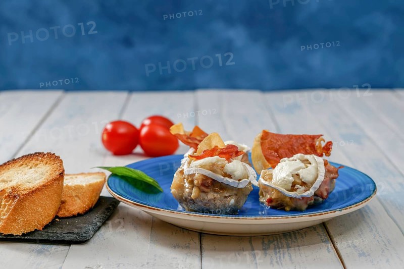 Mushrooms stuffed with goat cheese and iberian cured ham typical spanish tapa
