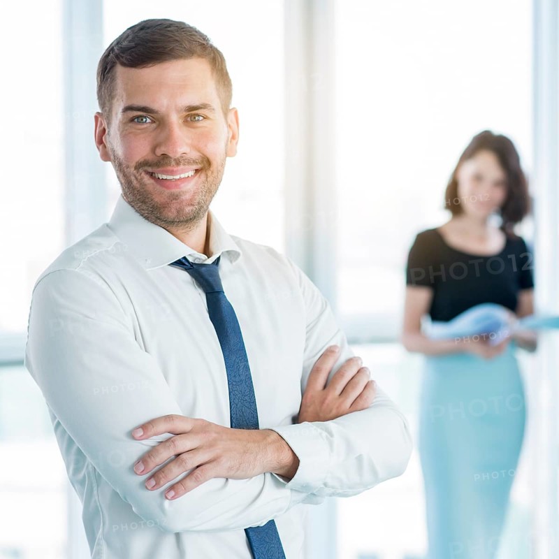 Portrait happy businessman with folded arms