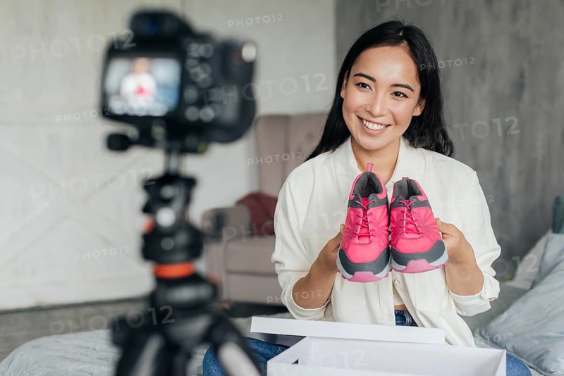 Woman vlogging with her sports shoes