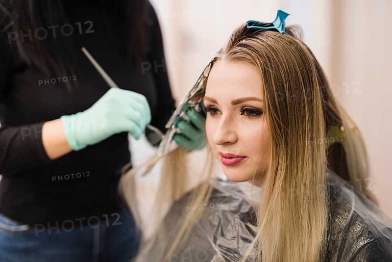 Blonde girl getting her hair dyeing