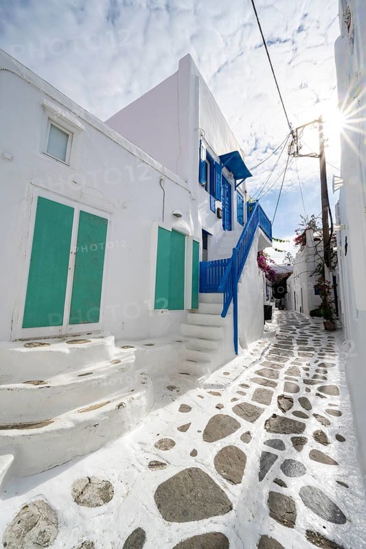 Cycladic white houses with colourful shutters and doors