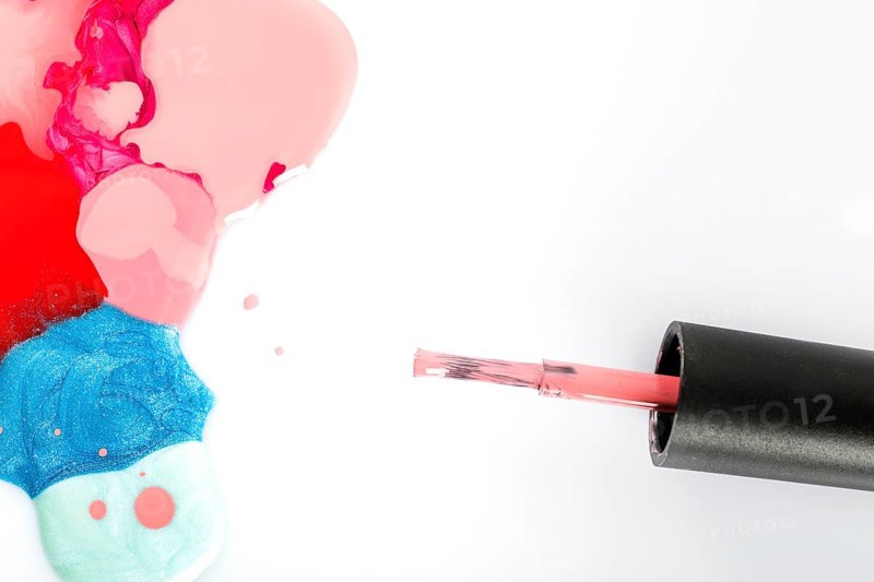 High angle view multi colored nail polish brush white background