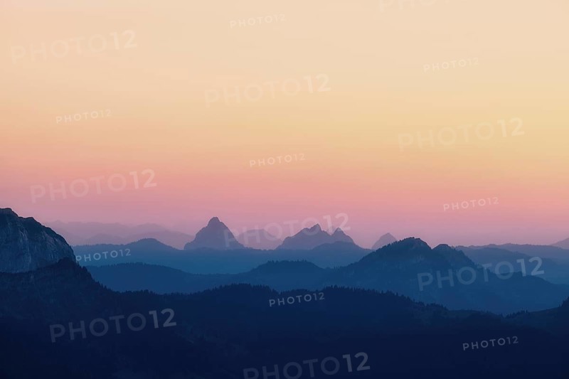 Hilly landscape with mountains Kleiner and Grosser Mythen after sunset