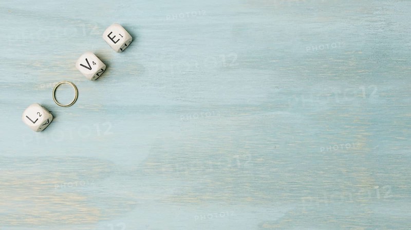 Overhead view text made with cubes wedding ring corner wooden backdrop