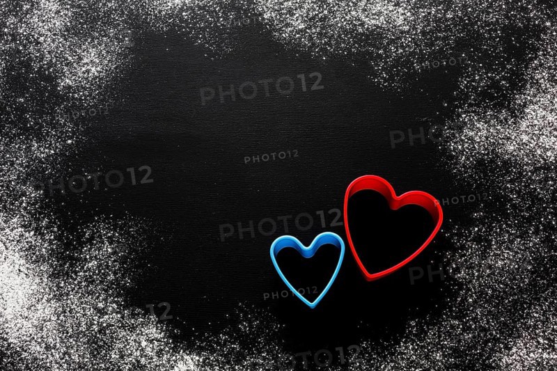 Flat lay colorful heart shapes with flour copy space
