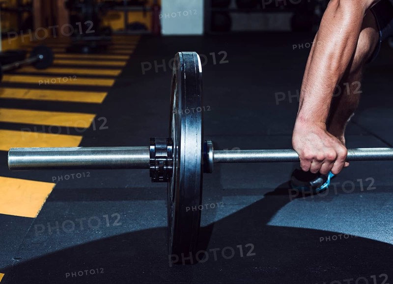 Close up man s hand lifting barbell