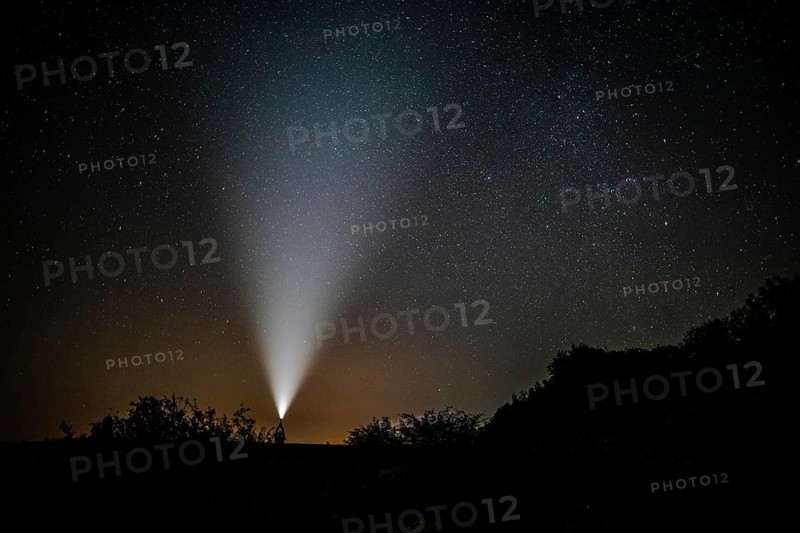 Man with flashlight enjoys beauty nature