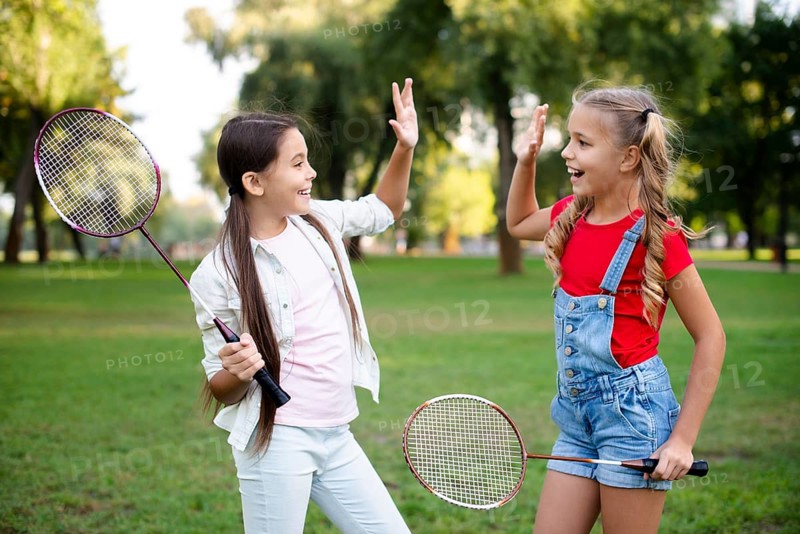Little badminton players giving five