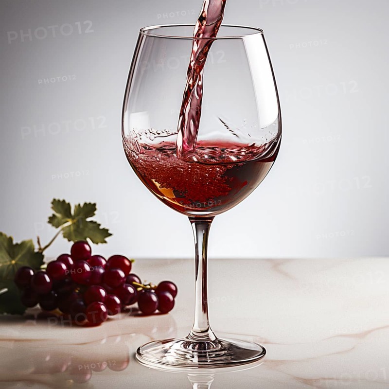 Wine is poured into elegant wine glasses