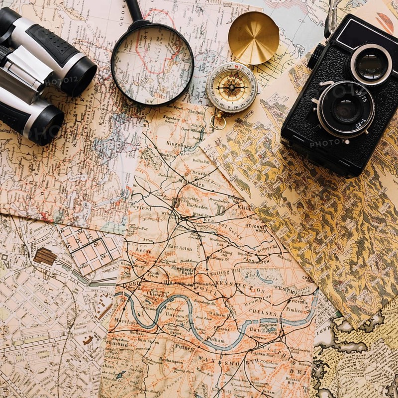 Camera compass near magnifying glass binoculars