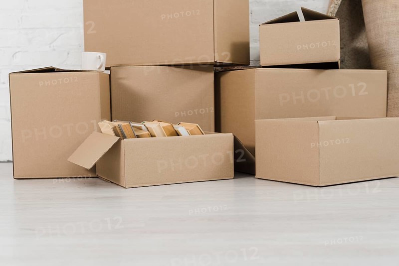 Pile cardboard boxes white floor