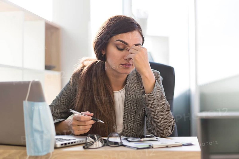 Tired businesswoman working desk with laptop