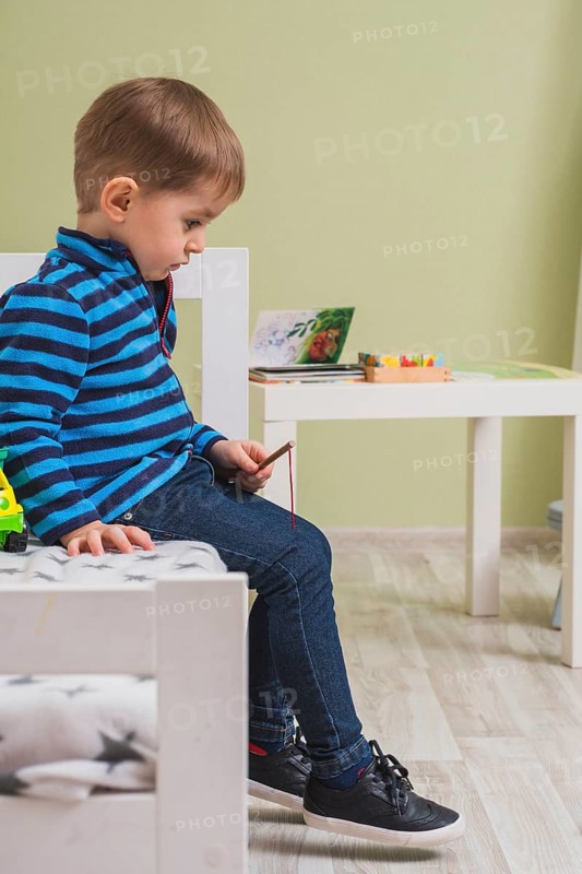 Pensive boy sitting bed